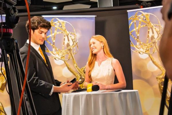 Students working backstage at a media event.