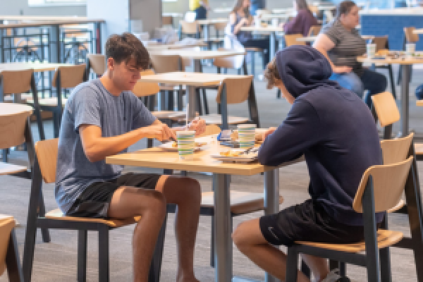 Two students sitting at a table in one of Kent State's dining areas.