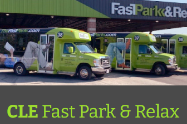 Green airport shuttles under an awning that reads "Fast Park & Relax"