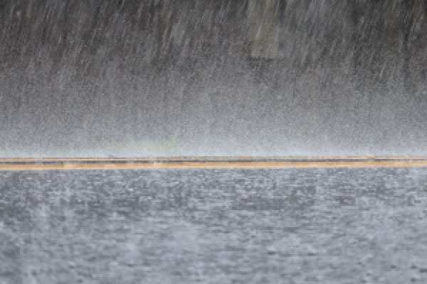 Rain water coming down on a road