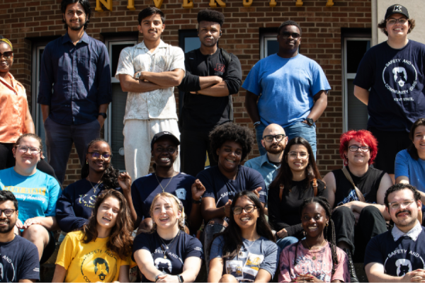 University Housing's Safety Assistants, a group of 20 individuals gathered on the steps of the MACC