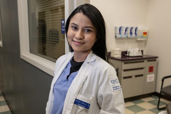 Saloni Christian, a third-year student at Kent State University's College of Podiatric Medicine, stands in a hallway at the college's clinic in Independence, Ohio. (Photo credit: Bob Christy)