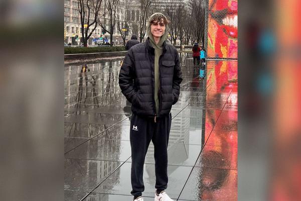 Student Ambassador standing out in the rain in a city
