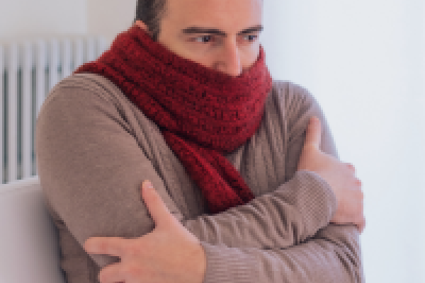 A man huddled up against the cold