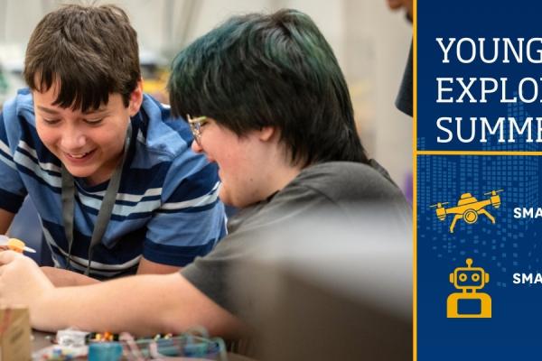 Young Explores Summer Camps banner featuring photo of two boys working on an engineering project. 
