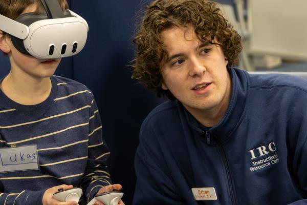 Student and child using virtual reality system in Learning Innovations Lab