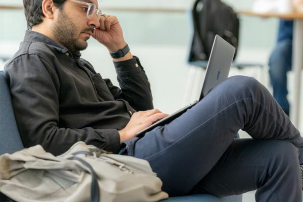 marketing ph.d student working in the Crawford Hall atrium