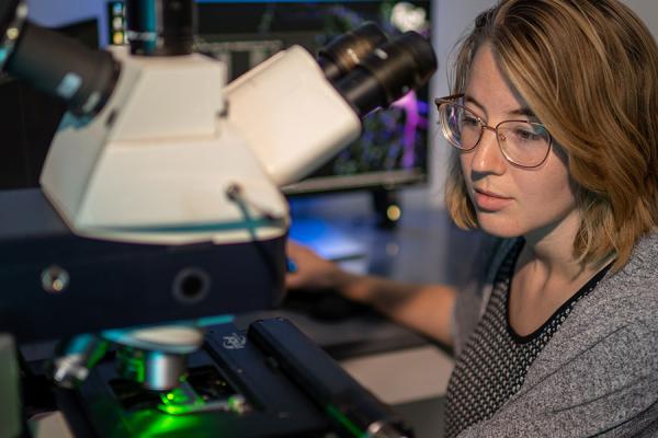 Student operating instruments in a lab.