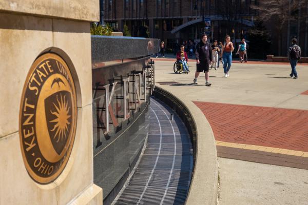 Students walking by the fountain on Risman Plaza