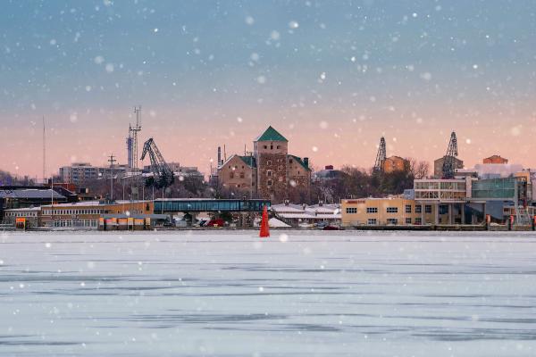 City of Turku in Finland, falling snow, frozen lake.