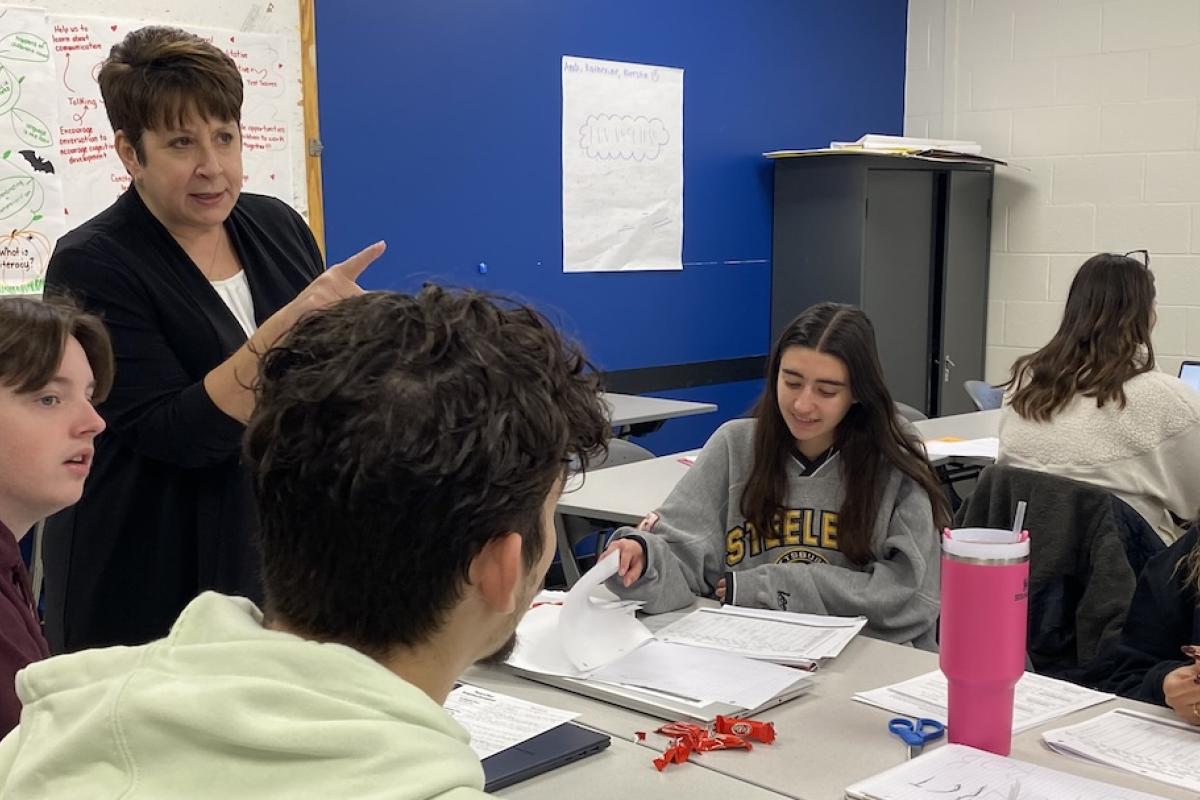 Professor Cheryl Radis instructing a group of students in the classroom