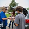 �Ը������� President Todd Diacon hands a pair of �Ը�������-branded socks to a student during Move-In.