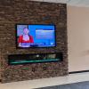 Large screen above fireplace in student center with KSTV news showing on it