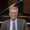Kent McWilliams headshot in Ludwig Recital Recital in front of Steinway grand piano
