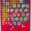 An art quilt composed of solar plate prints, boasting vibrant reds and greens