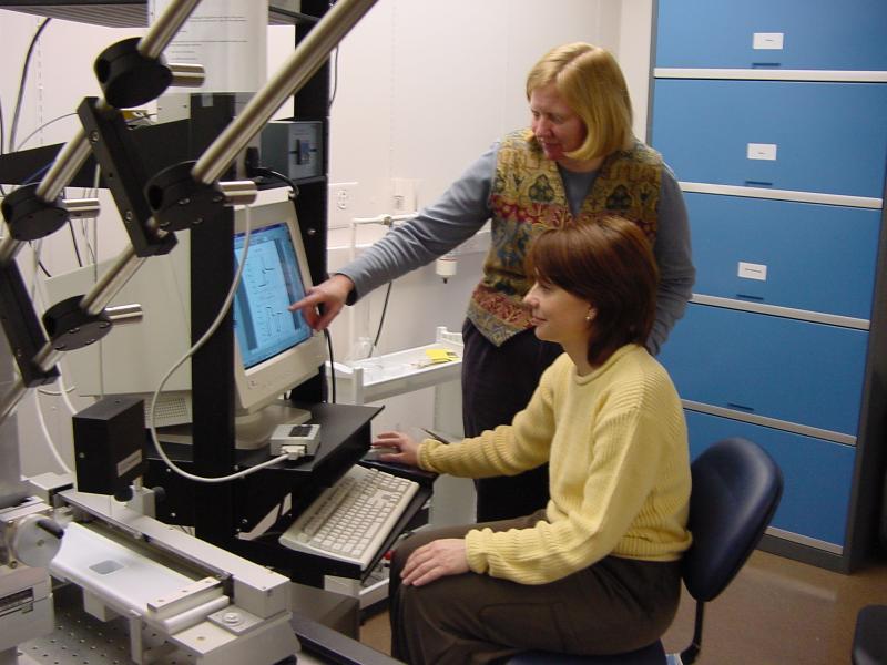 Svetlana Primak (seated) discusses properties of a molecularly-thin polymer layer with her PhD Physics adviser, Prof. Elizabeth Mann.